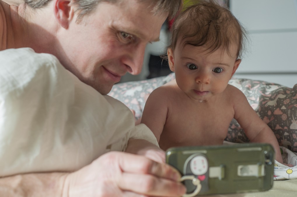 conversation with granny baby and father using mobile phone to talk to grandmother family video call t20 YwzQaj