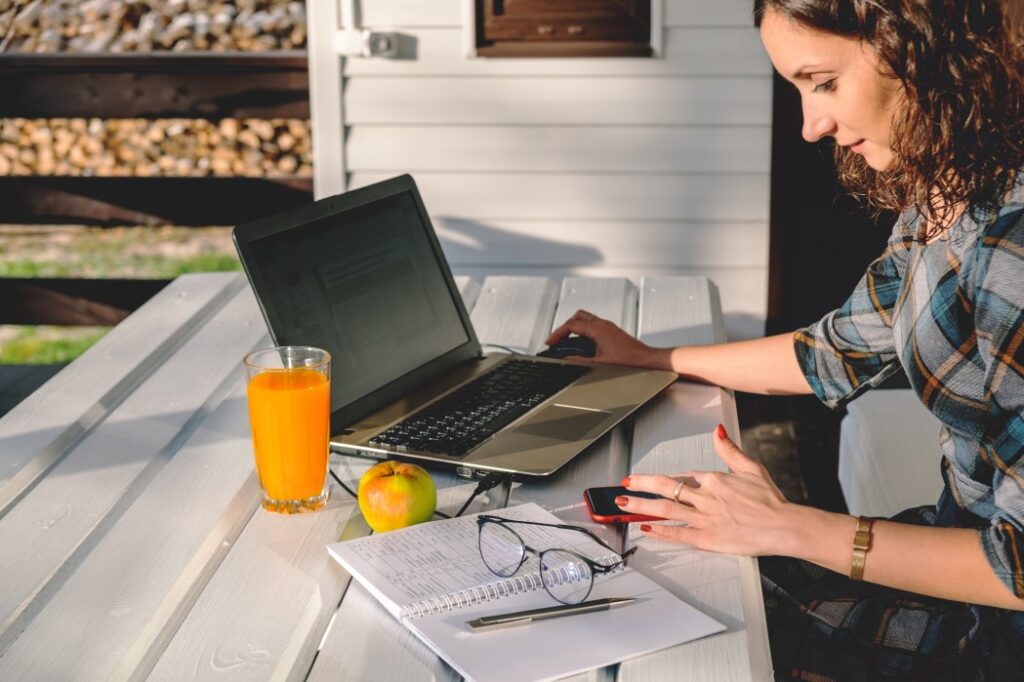 young businesswoman working on laptop from home office freelance woman using mobile technologies t20 mR0zjr